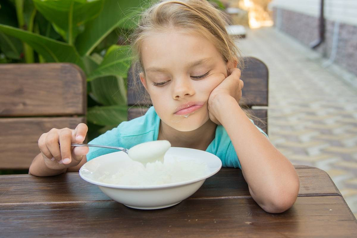 Girl serve porridge